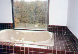 Upstairs tiled jacuzzi tub with large window